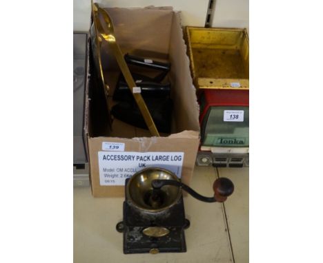 A vintage coffee grinder together with a brass ladle and charger, two vintage irons etc.