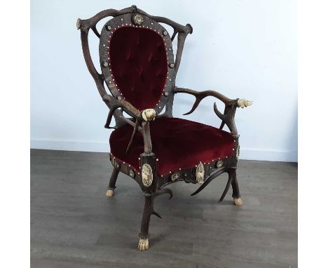 VICTORIAN ANTLER 'THRONE' CHAIR LATE 19TH CENTURY the shaped back with carved panel depicting a deer and further roundels, th