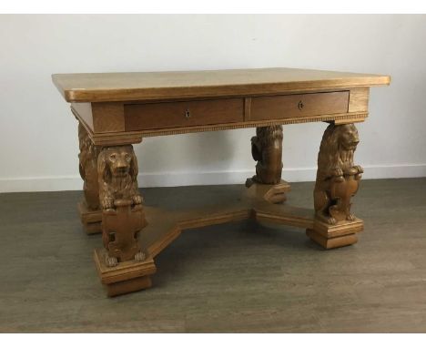 OAK LIBRARY TABLE EARLY 20TH CENTURY the rectangular top with two short frieze drawers, raised on carved lion and shield supp