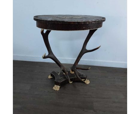 VICTORIAN AND LATER HORN VENEERED CENTRE TABLE the oval top inset with carved ivory detail of deer, raised on twin antler sup