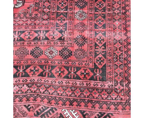 PERSIAN BOKHARA RUG MID-LATE 20TH CENTURY with repeated elephant foot on red ground, hand-knotted273cm x 214cmNo major issues