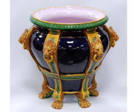 Large Minton style planter of tapering form with gadrooned rim over lion masks and lion paw feet, 35cm high. Condition Report