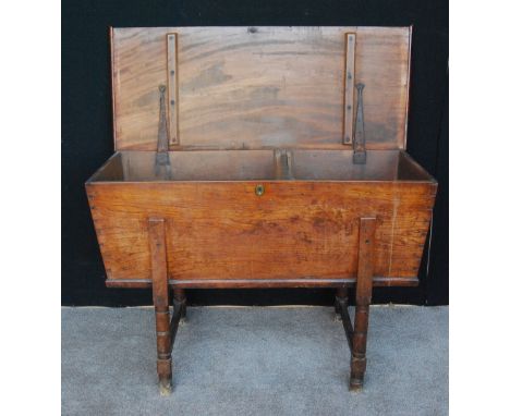 19th century fruitwood dough bin, the rectangular hinged top with tapering trunk raised on ring turned legs united by stretch