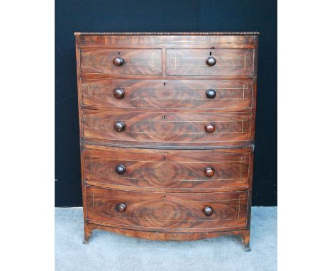 19th century mahogany and brass inlaid bowfront chest, the beaded top over two short and four graduated long drawers, shaped 