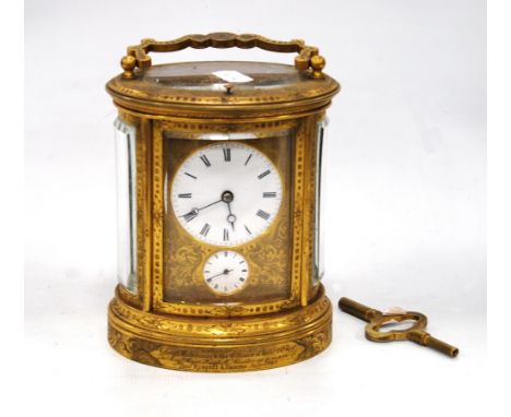 Mid 19th century repeater carriage clock of oval form mounted by a handle with etched decoration, Roman numerals, subsidiary 