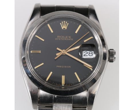 Rolex gent's Oysterdate watch, black dial, manual, in stainless steel with Rolex bracelet, c. 1960.