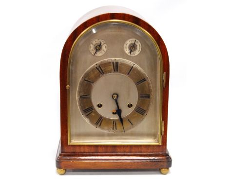Gustav Becker bracket clock of arched form with brass and silvered face, applied chapter ring and striking rods.