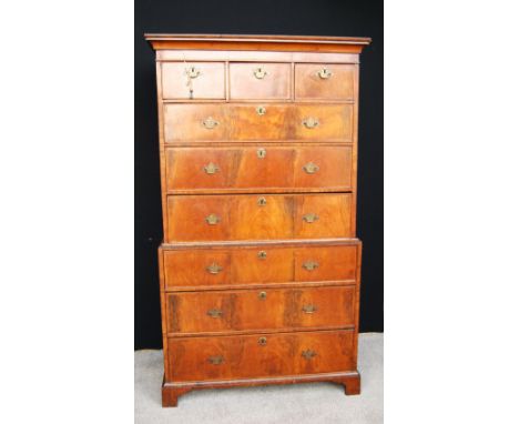 George III walnut chest on chest, the projected moulded cornice over three short drawers, six long feather bonded drawers and