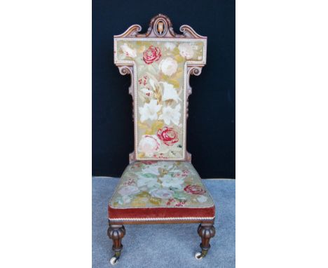 Victorian rosewood prie-dieu, with elaborate carved top rail, floral tapestry back and seat raised on shaped turned legs term