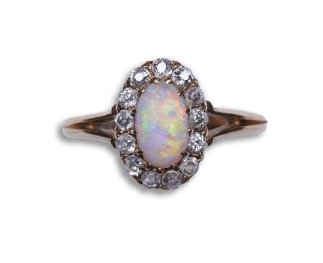 Henry Newman, an Edwardian opal and diamond ring, Melbourne, Australia, circa 1900 of cluster design, set with a cabochon opa