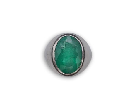 An emerald signet ring, rubover set with an oval emerald measuring approximately 15.7mm x 10.9mm x 7.8mm, calculated to weigh