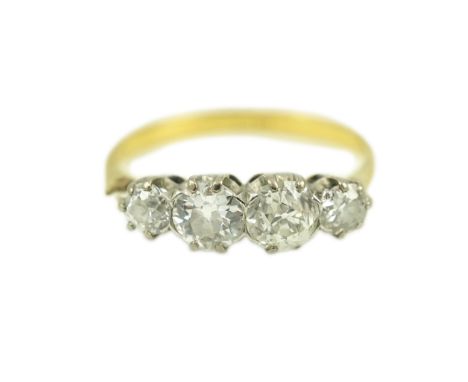 A four-stone diamond ring, early 20th century, claw-set with four antique circular-cut diamonds totalling approximately 0.90 