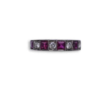 A ruby and diamond half eternity ring, set to the front with a band of step-cut rubies and brilliant-cut diamonds in alternat