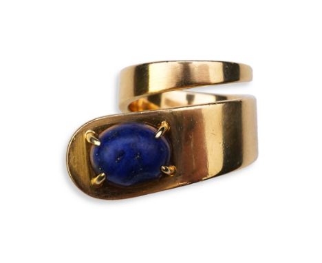 Jean Dinh Van for Cartier, a lapis lazuli ring, circa 1970 designed as a tapered coil, claw-set with a cabochon of lapis lazu