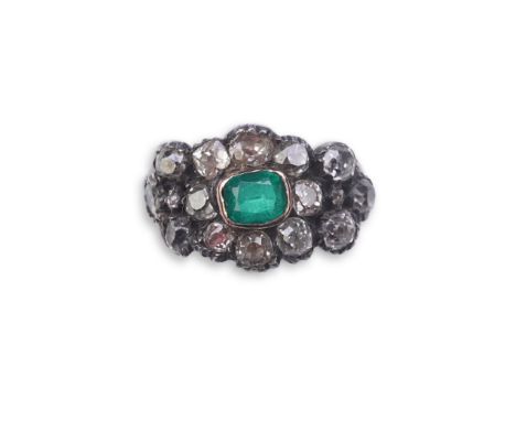 A Georgian diamond and simulant emerald ring, circa 1800 of floral design, set with cushion-shaped diamonds in closed-back se