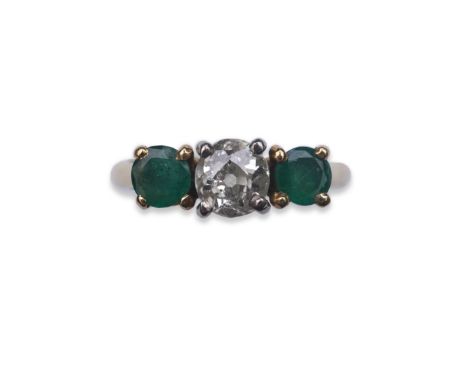 An emerald and diamond three-stone ring, claw-set with a circular-cut diamond weighing approximately 0.40 carats, between sho