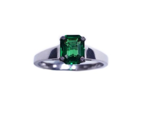 A tsavorite garnet ring, claw-set with a step-cut tsavorite garnet weighing 1.16 carats, size N1/2, stamped 750  Very attract