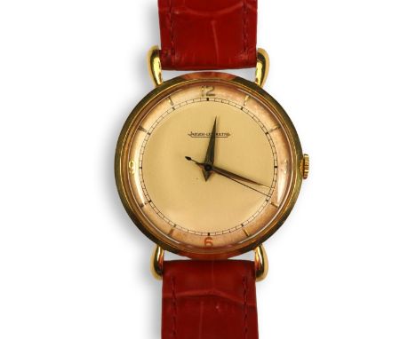 A gentleman's 1950's 18ct gold Jaeger LeCoultre manual wind wrist watch, on a later associated leather strap, the cream dial 
