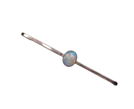 An Edwardian gold and opal brooch, early 20th century, centring on a cabochon opal measuring approximately 13 x 11 x 2.9mm, t