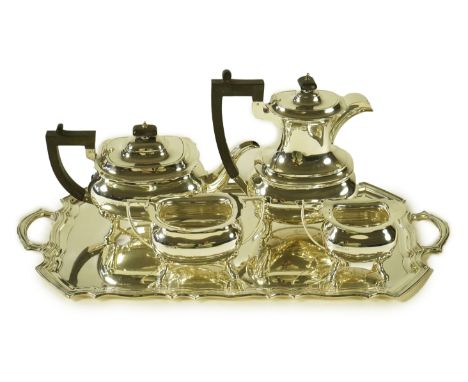 An Elizabeth II silver four piece tea service and two handled tea tray, by Walker &amp; Hall, the tea set of oval form compri
