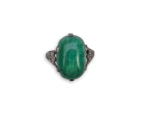 An emerald and diamond ring, early 20th century, claw-set with a cabochon emerald, to shoulders millegrain-set with single-cu