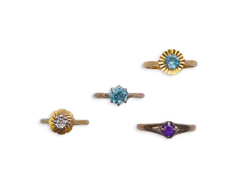 Four rings comprising: a ring set with a circular-cut blue zircon in a faceted border, size M, stamped 18CT; another claw-set