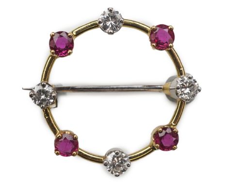 A ruby and diamond brooch, designed as a ring of alternating circular-cut rubies and brilliant-cut diamonds, mounted in gold,