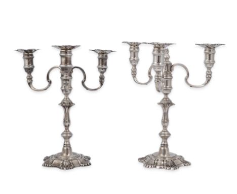 A pair of Elizabeth II cast silver three branch, three light candelabra, by J.B. Chatterley &amp; Sons Ltd, with waisted knop