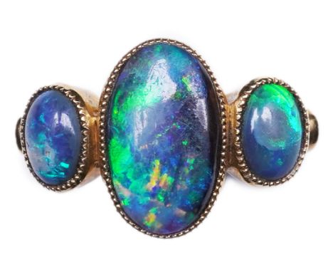 A Victorian black opal ring, circa 1881, set with three cabochon black opals, mounted in 18ct gold, size R, British hallmarks