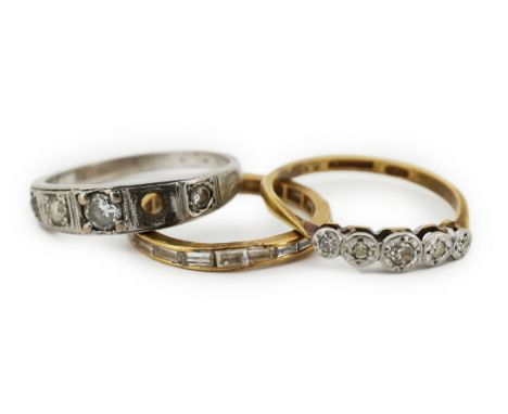 Three diamond rings, comprising: a five-stone diamond ring, stamped 18CT &amp; PLAT; an eternity ring channel-set with baguet
