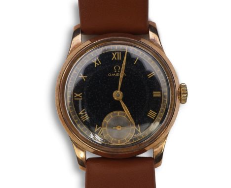 A gentleman's 1940's 9ct gold Omega manual wind wrist watch, on a later associated leather strap, with black Roman dial and s