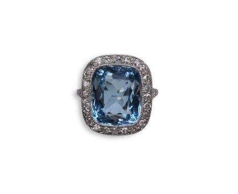 An attractive aquamarine and diamond ring, of cluster design, set with a cushion-shaped aquamarine, to a border and V-shaped 