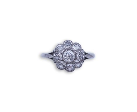 A diamond ring, circa 1920, designed as a floral cluster of circular-cut diamonds totalling approximately 0.60 carats, in a m