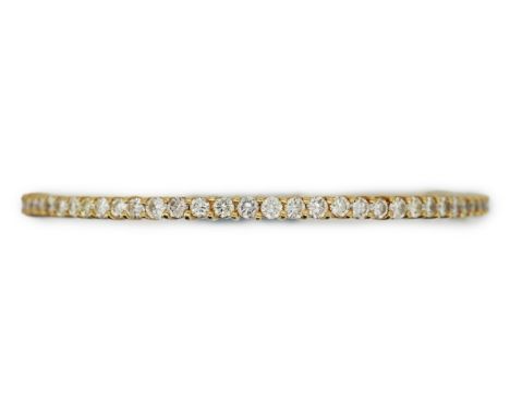 A diamond bangle, of hinged design, set throughout with brilliant-cut diamonds totalling approximately 3.90 carats, mounted i