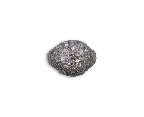 A diamond dress ring, in the Belle Epoque style, of bombé design in millegrain-bordered openwork, set with circular- and rose