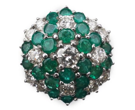 An emerald and diamond cocktail ring, of bombé cluster design, set with brilliant-cut diamonds and circular-cut emeralds, mou