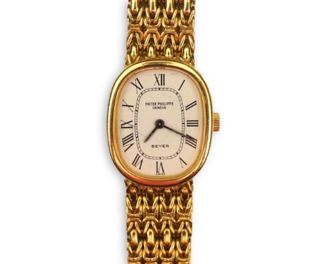 A lady's 18ct gold Patek Philippe manual wind wrist watch, on an integral 18ct gold Patek Philippe bracelet, with oval Roman 