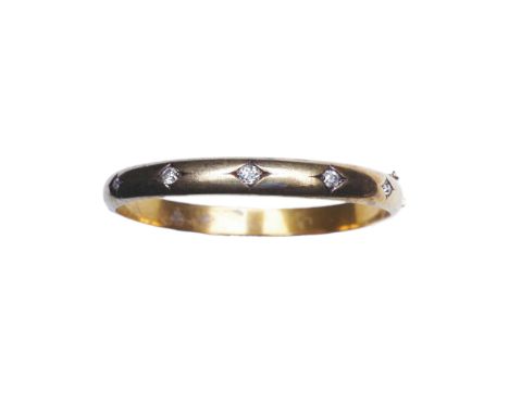 An Edwardian diamond bangle, early 20th century, of hinged design, the front set with five cushion-shaped diamonds in lozenge