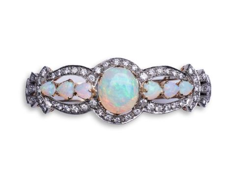 An opal and diamond bangle, of hinged design, the front set with cabochon and heart-shaped opals within openwork borders of b