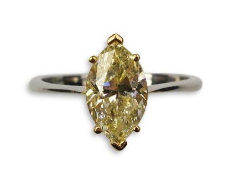 A yellow diamond solitaire ring, claw-set with a marquise-shaped diamond of yellow tint weighing 2.00 carats, mounted in plat
