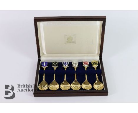A boxed set of silver commemorative spoons, limited edition 104/2000, each spoon terminating with an enamel plaque repesentit