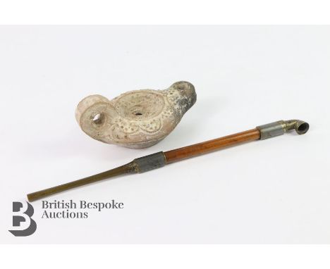 Roman style oil lamp, measures approx. 10cms, together with an opium pipe, approx. 12cms in length.
