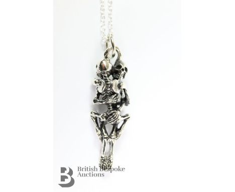 Silver skeleton pendant, suspended from a fine chain, approx 27 cms in length.&nbsp;