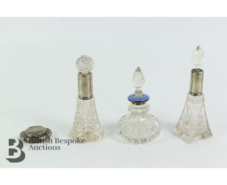 Three cut-glass scent bottles, one with blue enamel collar and a silver-plated miniature compact.