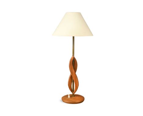 A 1970s teak and brass table lamp, the central brass column applied with teak motifs to a circular base65.5cm high