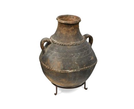 A North African stoneware pot, 20th century, of globular form with incised and applied banded decoration, modelled with two c