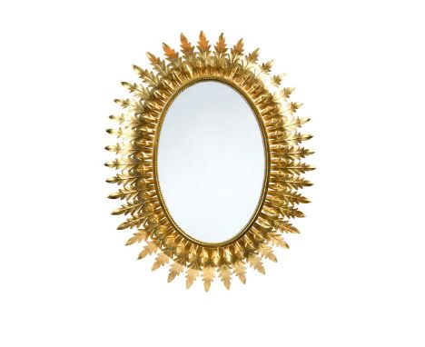 A large scale mid-century 'gilt-metal' sunburst mirror, the oval plate with repeating cut metal leaf design and wired for bac