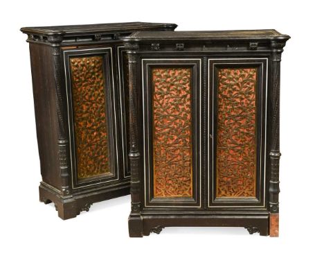 A fine pair of Puginesque pier cabinets, circa 1870, the ebony and coromandel cabinets inlaid with ivory, the silk boarded do