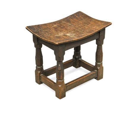 Robert 'Mouseman' Thompson, a burr oak topped stool, the dished rectangular seat on four shaped supports united by stretchers