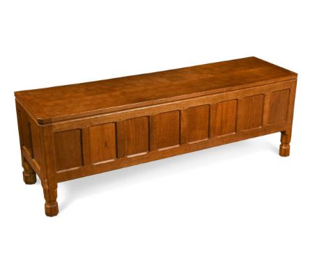 Robert 'Mouseman' Thompson, an oak coffer, the adzed hinged rectangular top above an eight-panelled front raised on waisted o